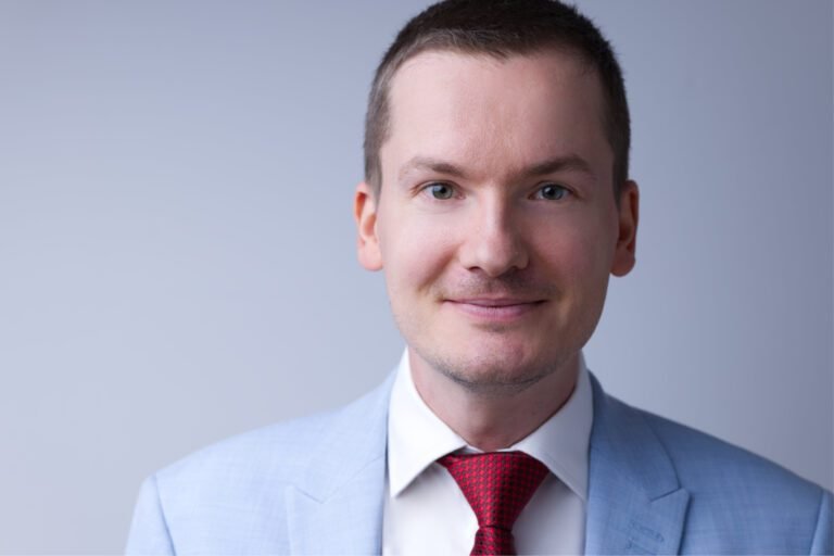 Male headshot against a light background, taken by a Kent headshot photographer