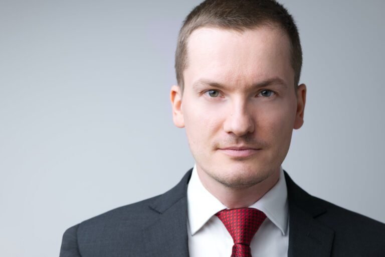 Professional headshot from indoor photo shoots in Kent, featuring a man in a suit against a clean studio background.